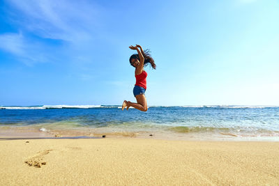Full length of woman standing on beach