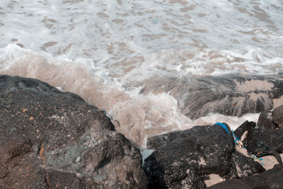 High angle view of rocks at sea shore