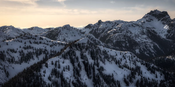 Scenic view of snow covered mountains against sky