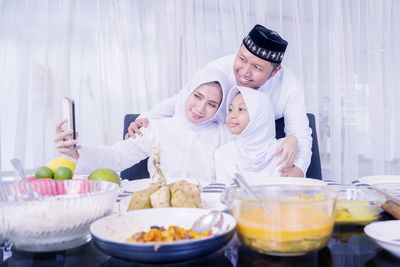 High angle view of father with ice cream on table