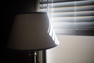 Close-up of electric lamp on table at home