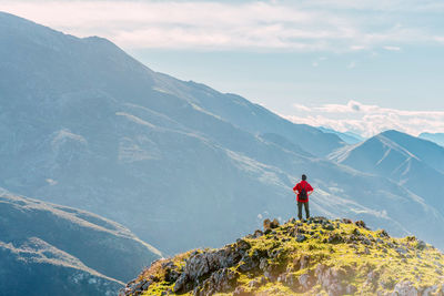 Man standing on mountain against sky