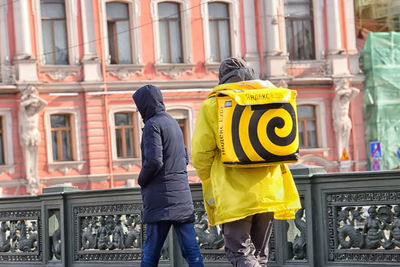 Rear view of man standing in city