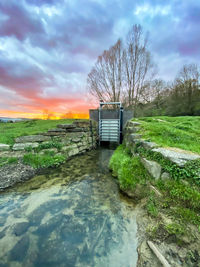 Scenic view of river against sky during sunset