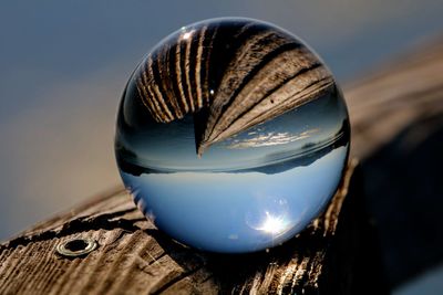 Close-up of crystal ball on wood