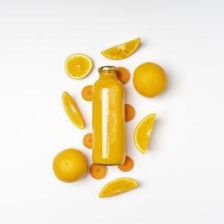 High angle view of lemon and slice over white background