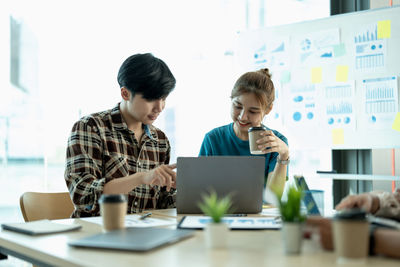 Businesswoman using laptop at office