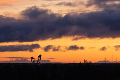 Scenic view of silhouette landscape against orange sky