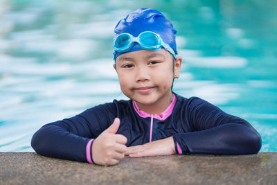 Portrait of young woman swimming in pool