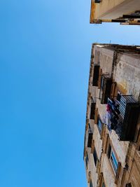 Low angle view of building against clear blue sky