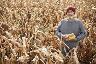 Full length of a young man standing in field