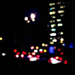 Low angle view of illuminated street lights at night