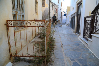 Footpath amidst buildings in city