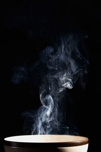 Close-up of smoke emitting from black background