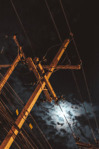 Low angle view of crane against sky at night