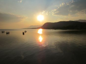 Scenic view of lake against sky during sunset