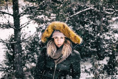 Portrait of woman in warm clothing during snowfall