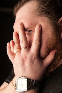 Close-up portrait of man with hands