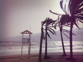 Lifeguard hut on beach against sky