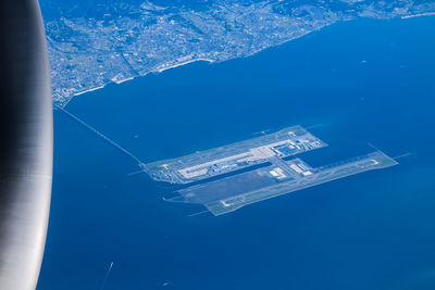 Aerial view of sea against blue sky