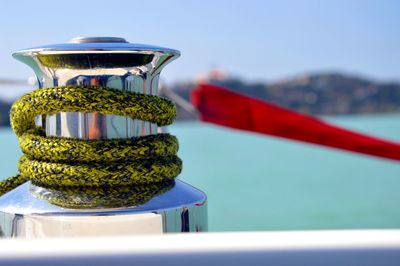 Close-up of rope handle on boat in sea