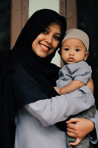 Portrait of smiling woman with son