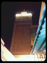 Low angle view of illuminated building at night