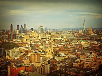 Cityscape against cloudy sky