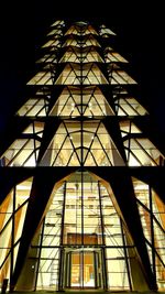 Low angle view of illuminated building against sky at night