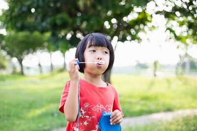 Portrait of girl standing on field