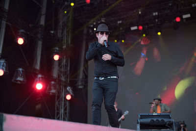 Man photographing illuminated city at night