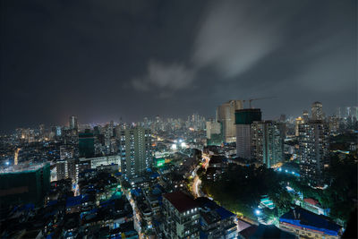 High angle view of illuminated city buildings against sky