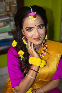 An indian woman wearing traditional dress and flower ornaments