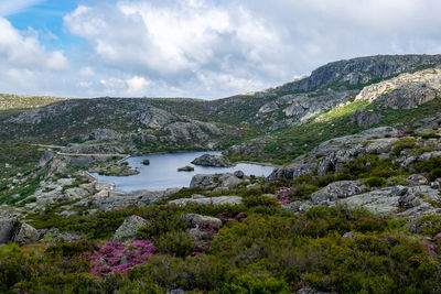 Scenic view of lake and mountains against sky