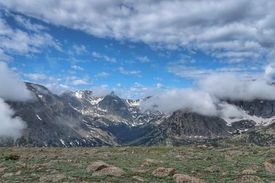 Landscape of billowing clouds atop the mountains in rocky mountain national park in colorado