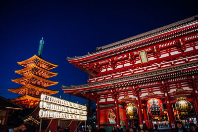 Low angle view of illuminated building against sky at night