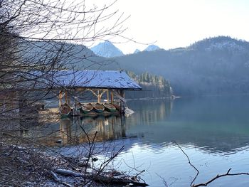 Scenic view of lake by mountains against sky