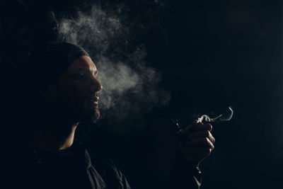 Portrait of man smoking cigarette