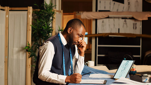 Side view of man working at office