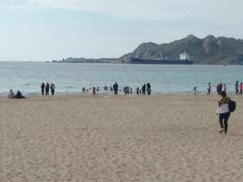 People on beach against sky