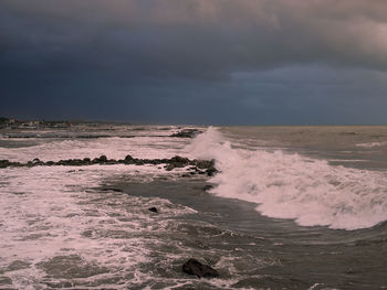 Scenic view of sea against dramatic sky