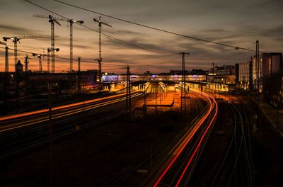 Train on railroad tracks against sky during sunset