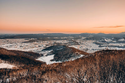 Scenic view of snowcapped mountains against sky during sunset