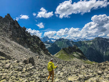 Rear view of person on mountains against sky