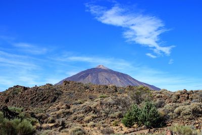 View of volcanic mountain against blue sky