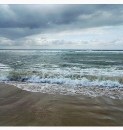 Scenic view of sea against cloudy sky