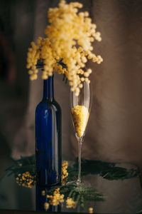 Close-up of wine glass bottle on table