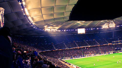 Crowd sitting on soccer field