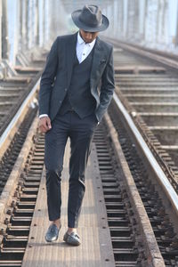 Full length of man walking at railroad station