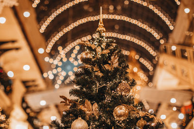 Magic christmas tree decorated with christmas balls. fairy details, golden bokeh lights, festive